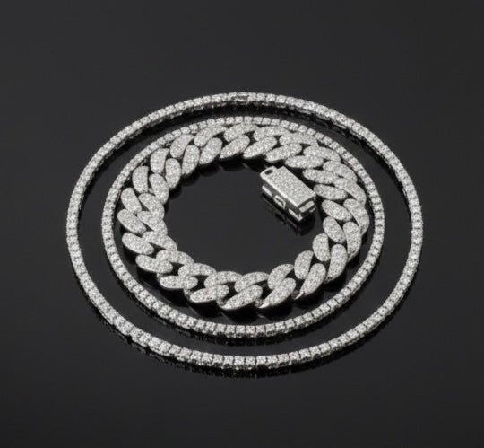 The VLTED 10mm Iced Cuban Link Bracelet and two matching tennis chains are displayed in concentric circles on a black surface.