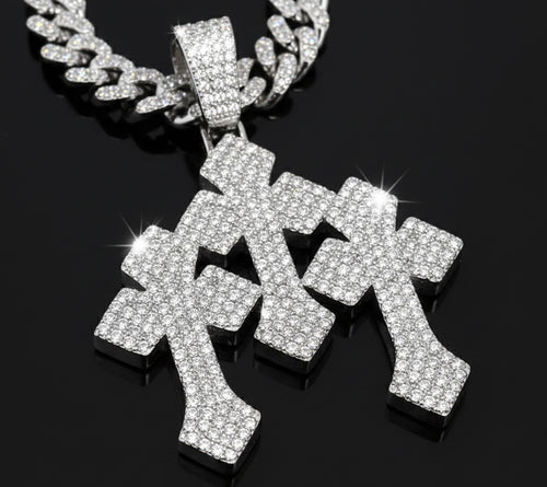 A close-up of the Iced Stacked Cross Pendant – 13mm Cuban Chain, featuring three diamond-encrusted crosses on a silver Cuban chain, set against a black background.