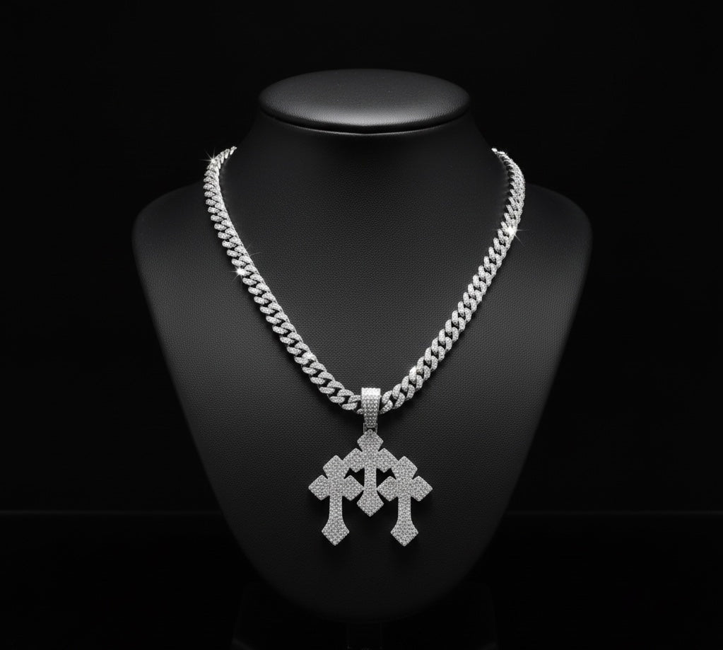 The Iced Stacked Cross Pendant – 13mm Cuban Chain, encrusted with diamonds, is displayed on a black jewelry bust against a dark background.