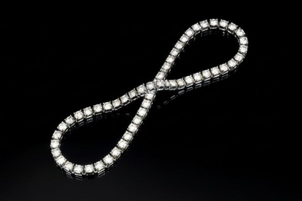 The VLTED 3mm Iced Tennis Chain sparkles with micro-pavé cubic zirconia on a glossy black surface, blending street-luxury style with elegance for a bold necklace statement.