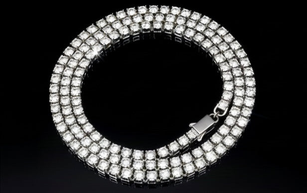 The VLTED 3mm Iced Tennis Chain features three rows of round stones on a silver band, offering street-luxury shine in a dazzling circular design, showcased on a black background.