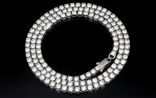 The VLTED 3mm Iced Tennis Chain features three rows of round stones on a silver band, offering street-luxury shine in a dazzling circular design, showcased on a black background.